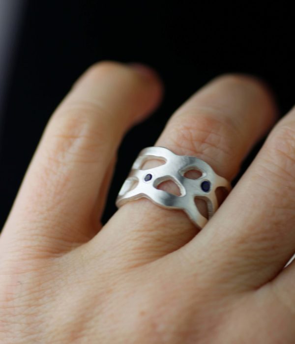 nebulawidebandweddingringwithbluesapphiresonhand scaled