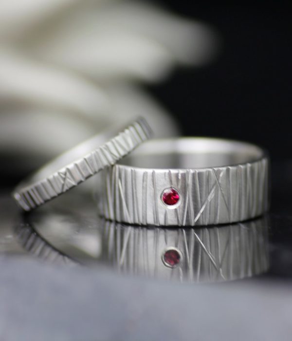 platinumandrubygenderneutralhandtexturedweddingbandset