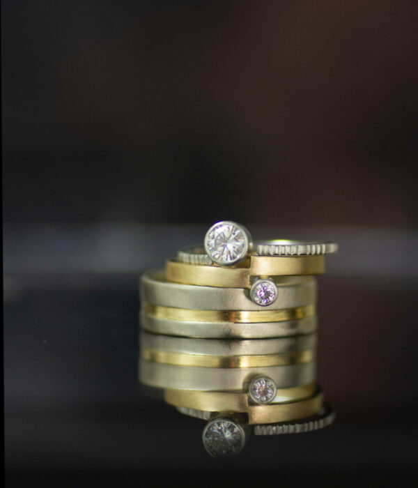 vis a vis bezel set lab diamonds in platinum and 14K yellow gold asymmetrical engagement ring with mixed metals gender neutral band