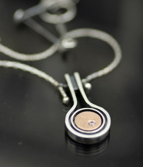 rose gold asteroid pendant on black