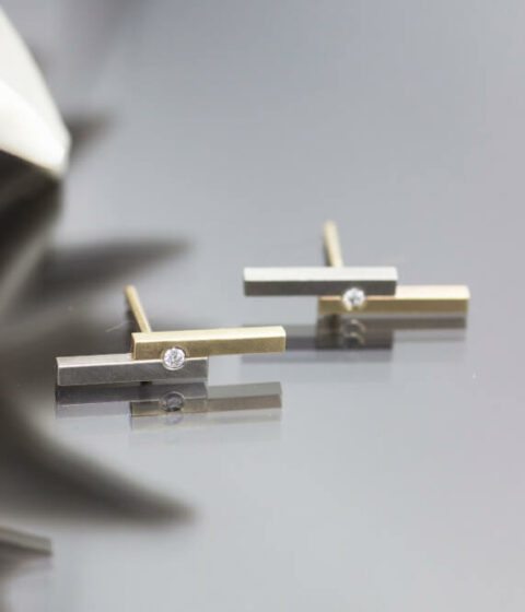 Image shows a modern style unique diamond earring design, with a fused bar and ethical diamond architectural jewelry design.