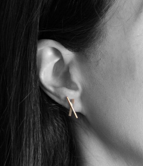 X earrings on model  e