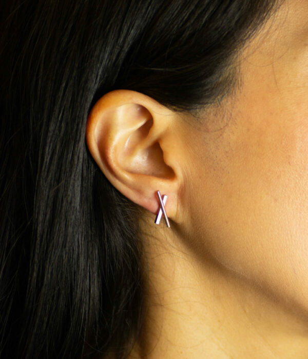X earrings on model