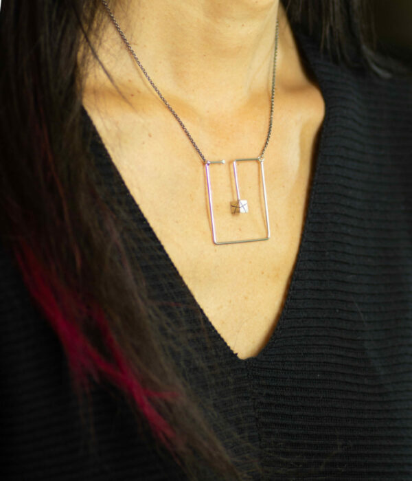 box in a box necklace on model