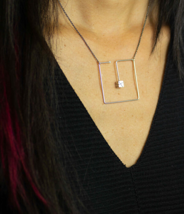 box in a box necklace on model