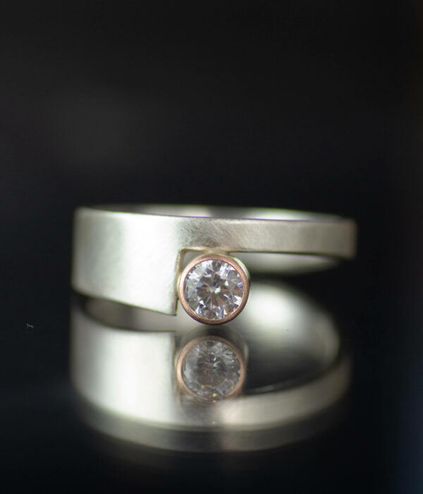 14k rose gold and platinum bezel set moissanite cut out asymmetrical minimalist contemporary engagement ring