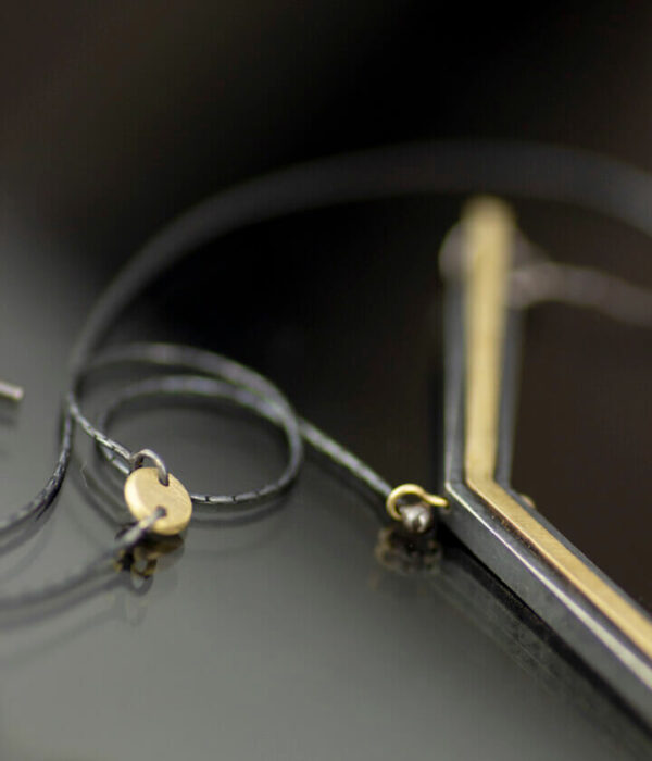 close up half Y mixed metals pendant necklace