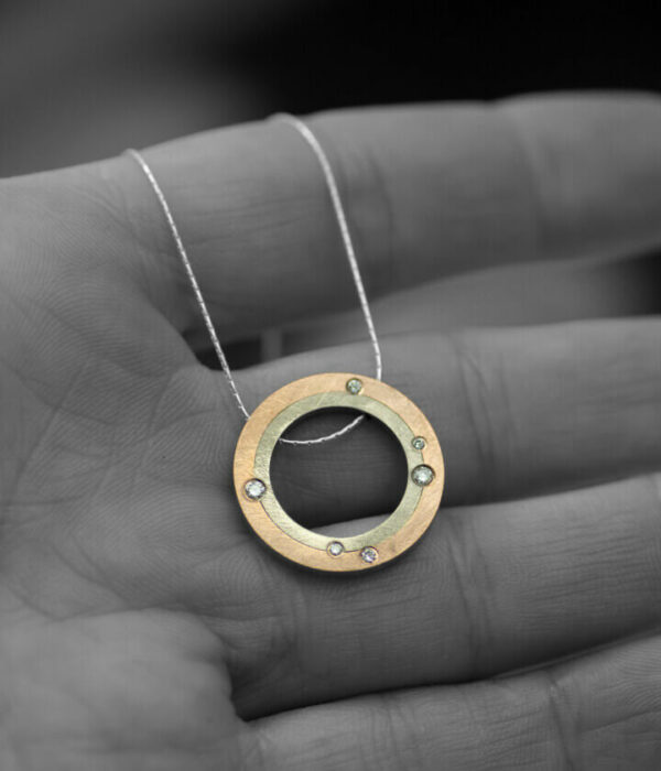 stargazer mixed metals pendant on hand