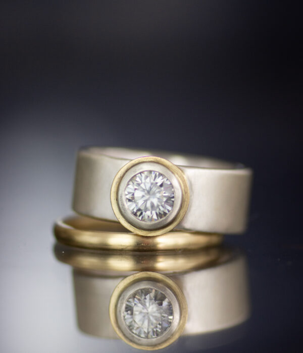 platinum and 14K gold mixed metals tessellated modern engagement ring with gray moissanite and 14K yellow gold half round wedding band