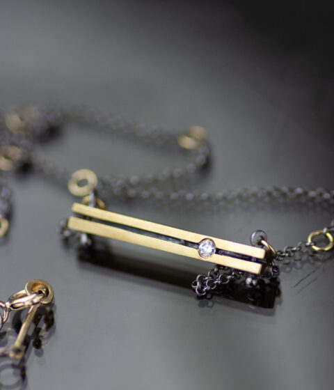 A thick geometric gold & diamond necklace design