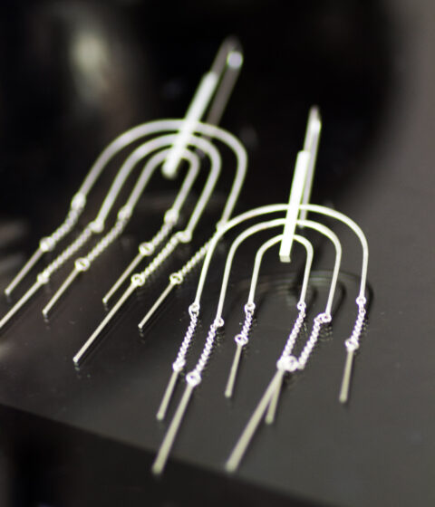 Picture of rainbow kinetic earrings made of sterling silver.