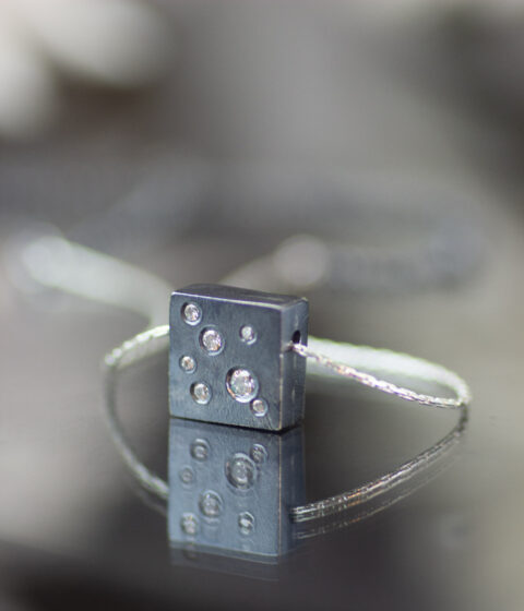 An oxidized sterling silver necklace with lab grown diamonds and an adjustable chain.